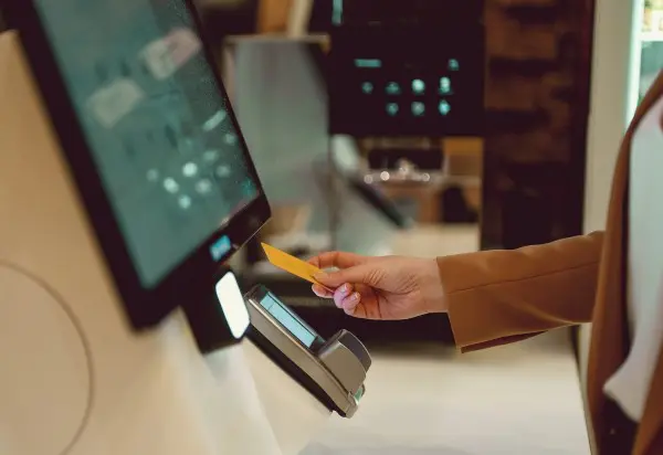 woman-paying-metroclick shutterstock 2360583725