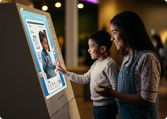 digital media family playing with digital kiosks